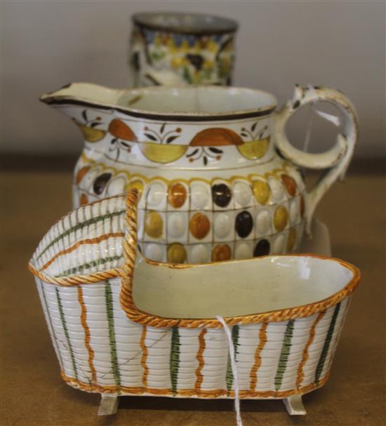 Early 19C Prattware creamware Bacchus pedestal mug, a Prattware cradle & a similar jug (all a.f)